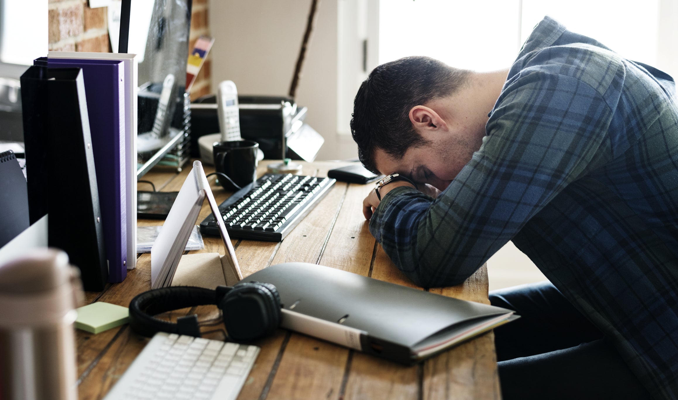Tired man napping on the working desk
