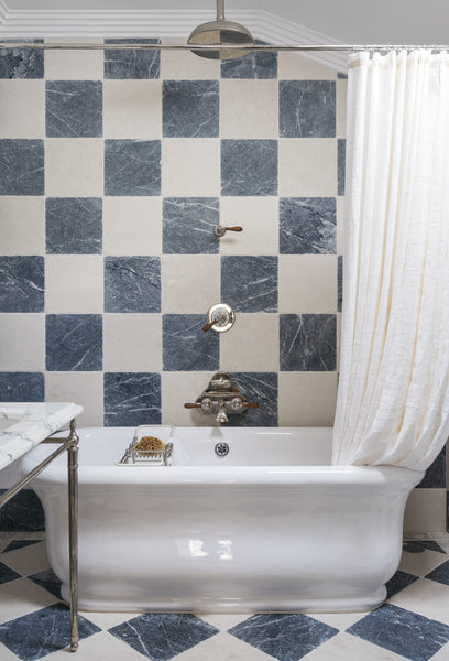 bathroom with checkered tile on wall