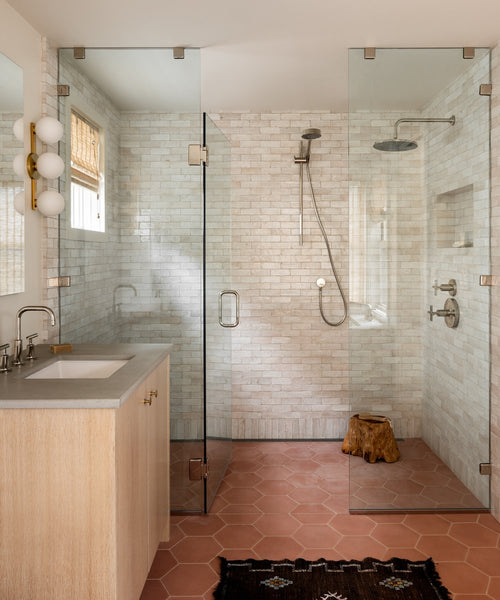 shower with handmade tile and terra cotta floors