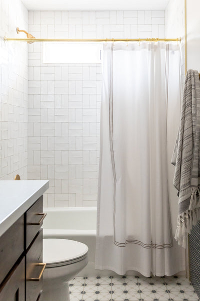 shower with subway tile in crosshatch pattern