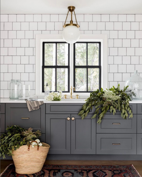 gray cabinets with white square tile backsplash