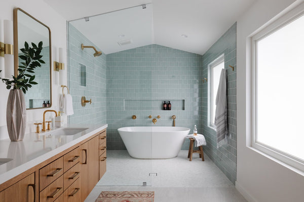 shower room with free-standing tub and blue tile