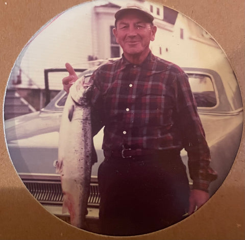 George Fletcher standing in front of a car holding a large fish