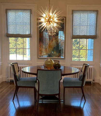 Sputnik or starburst chandeliers over a dining table