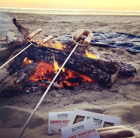 Olympia Provisions sausages roasting oven an open flamed fire at the beach