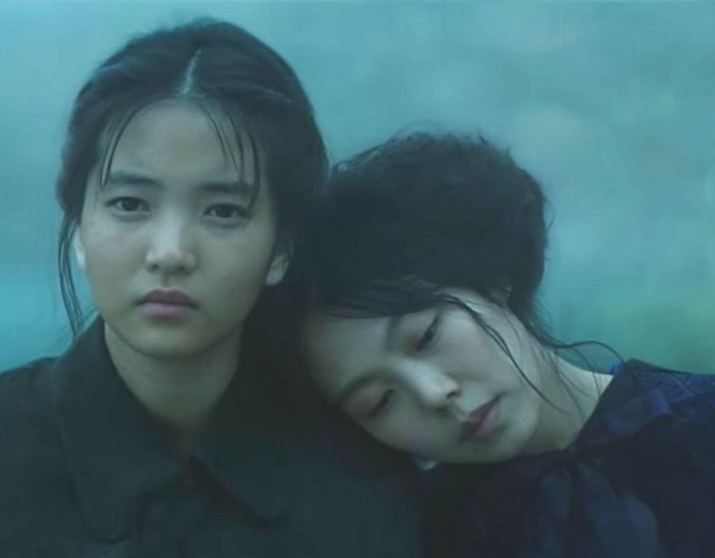 With help from an orphaned pickpocke, a Korean con man devises an elaborate plot to seduce and bilk a Japanese woman out of her inheritance. The two female heroines are pictured with one leaning her head on the other.