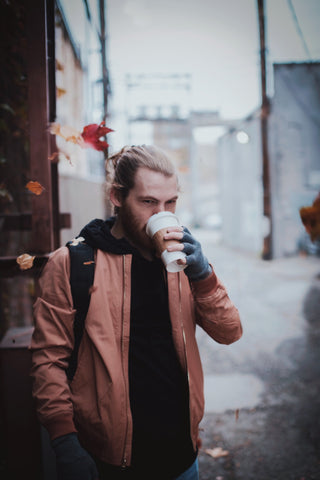 Model wearing a light brown jacket with a black hoodie underneath.