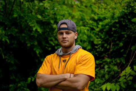 man wearing a t-shirt over a hoodie