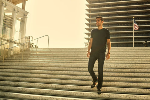 Man wearing True Classic Black Crew Neck T-Shirt walking down a flight of stairs