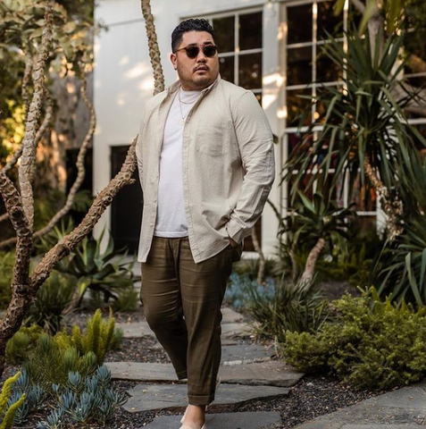 Man wearing a True Classic White Crewneck T-shirt under an cream colored button up shirt