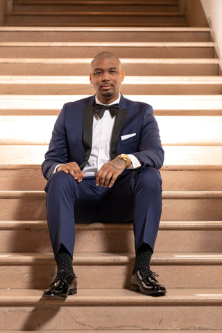 Man wearing dark navy tuxedo and white shirt