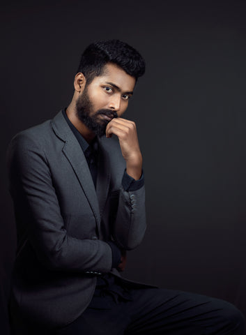 Man wearing gray suit and black button down shirt