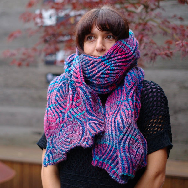 woman wearing an oversized brioche knitted scarf in blue and purple, willow scarf designed by nancy marchant