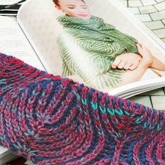 Progress shot of nancy marchants willow brioche knit scarf with her book sample in the background