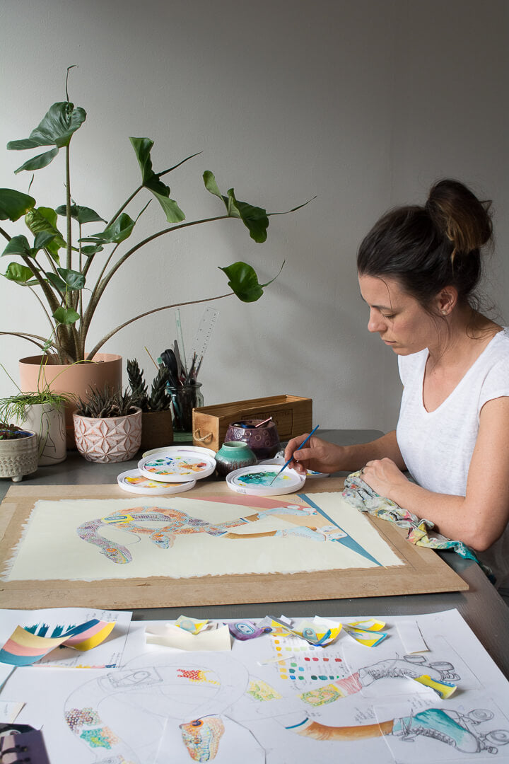 Jaelle Pedroli painting snake in roller skates in artist studio