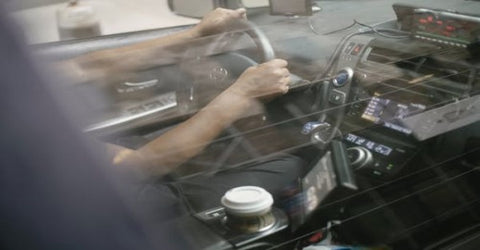  A man's hands on the steering wheel while driving