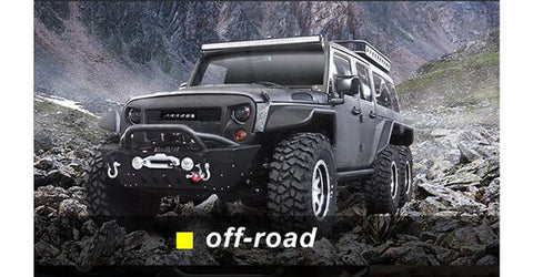 A grey Geep car with fantastic off-road lights parks on rocky ground in the valley.