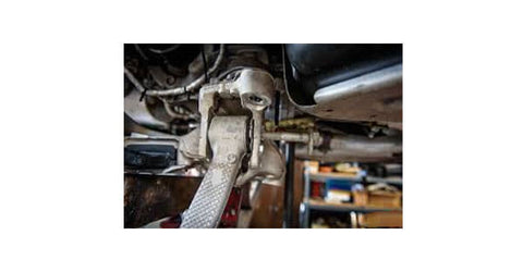 Use tool to remove control arm under car