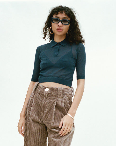 Photo of a model wearing a sheer navy cropped polo shirt by Maryam Nassir Zadeh.