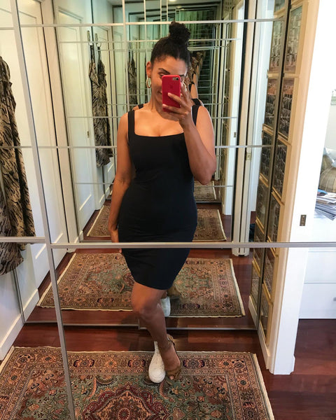 Courtney takes a mirror selfie wearing a black mini dress.