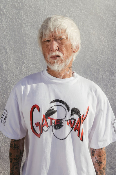 Photo of a white haired person wearing the warped eyes Aries short sleeve tee.