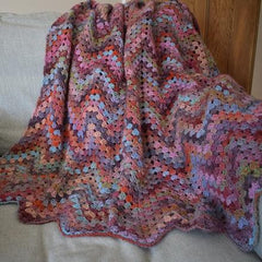 Multi coloured crochet blanket