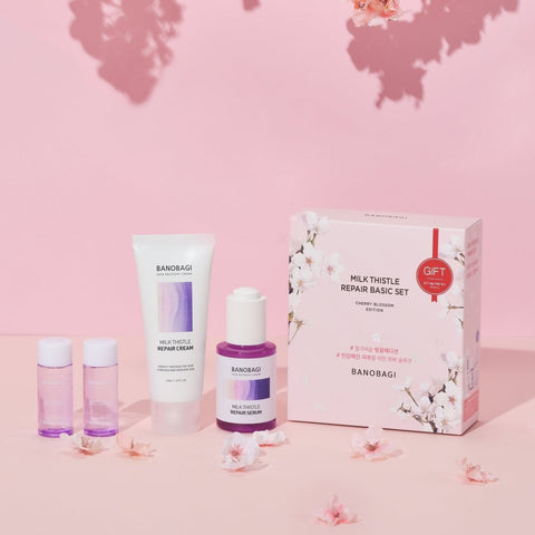 banobagi milk thistle repair basic set on display with cherry blossoms surrounding the products