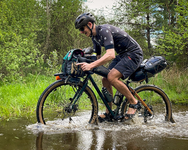 Crossing a river with a watertight bikepacking bag