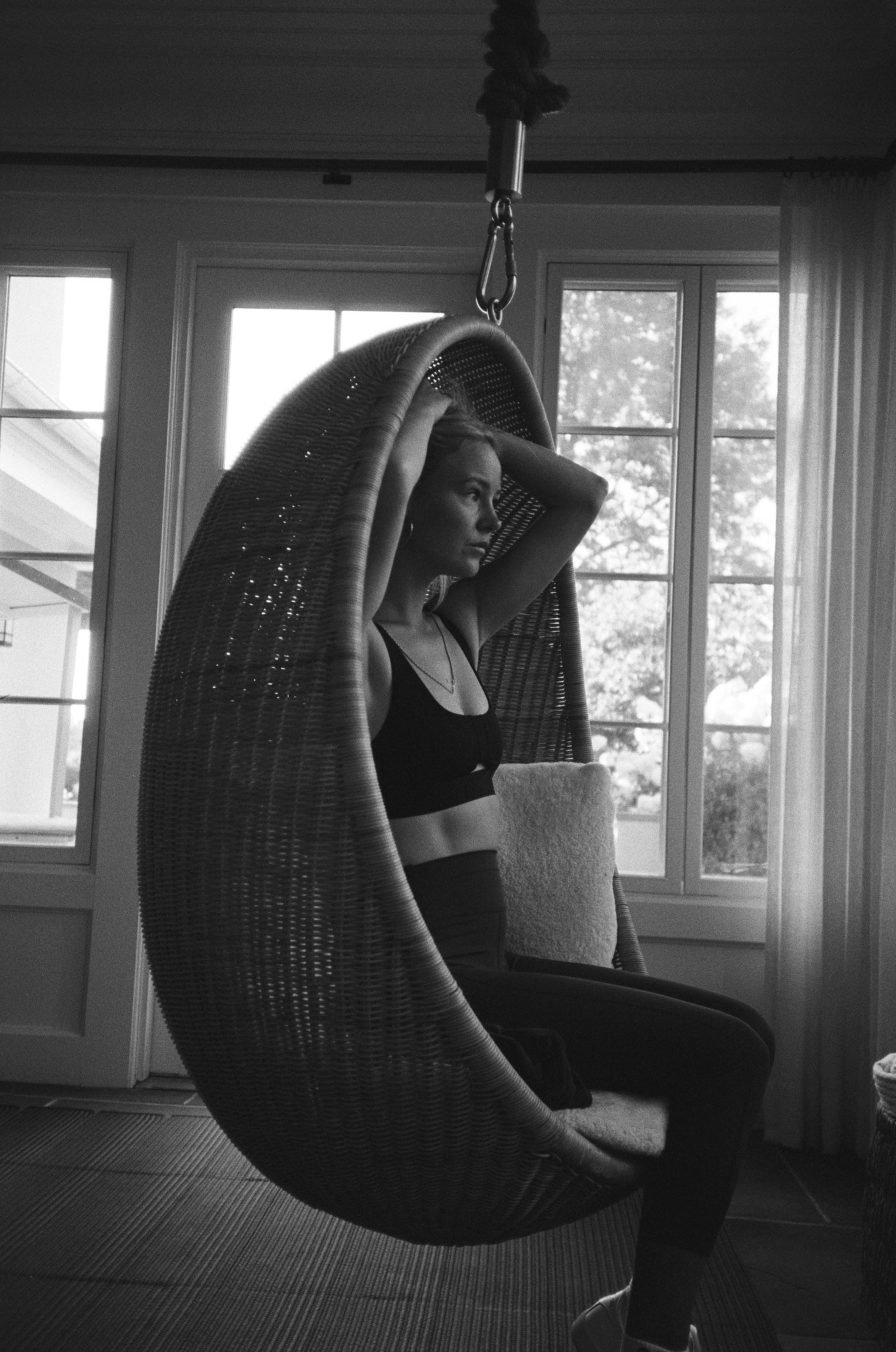 Wear One's At image of model sitting in a hammock chair black and white photo