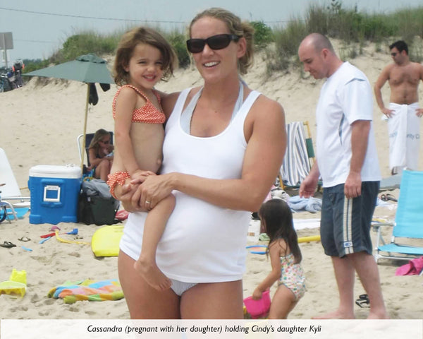 Cassandra pregnant with her daughter, holding Cindy's daughter, Kyli