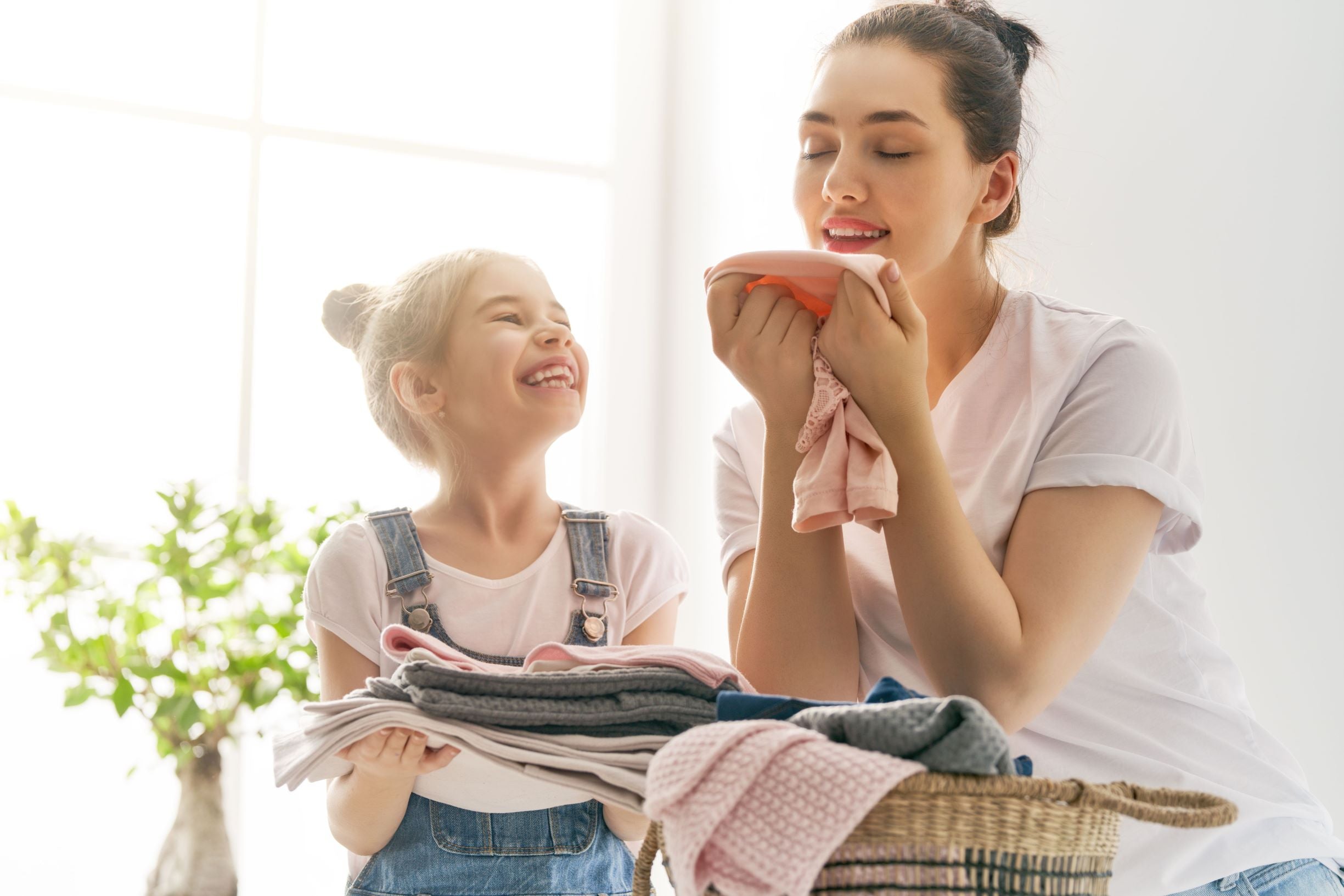 Woman placing mothballs (naphtalene) in her clothes Stock Photo