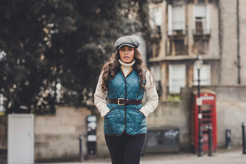 Lady walking in street wearing petrol blue quilted gilet