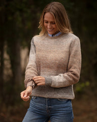 Woman wearing light brown jumper 