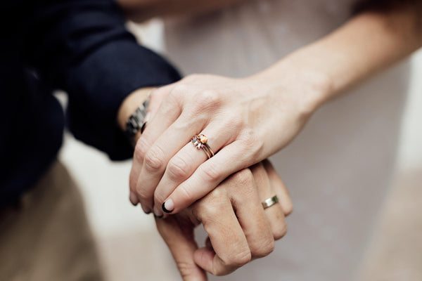 couple wearing bena jewelry wedding band and custom made engagement ring made in montreal