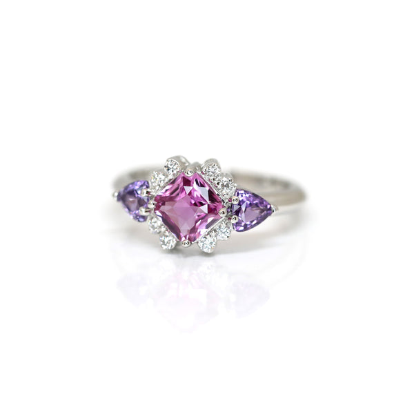 front view of pink sapphire and side purple trillion shape natural gemstone with icy diamond custom made in platinum fine bridal ring montreal handmade on white background