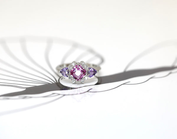 custom made bridal ring montreal pink and purple sapphire diamond platinum bena jewelry design on black and white background