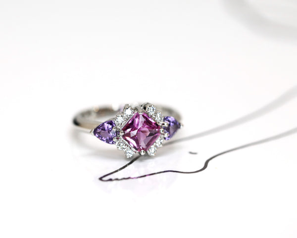 pink sapphire and purple gemstone diamond platinum custom made ring in montreal by bena jewelry on a white background