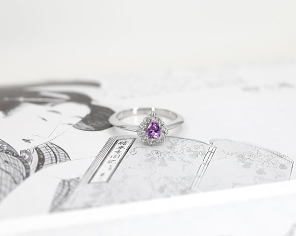 top view of pear shape pink sapphire diamond white gold bridal ring montreal made on white background