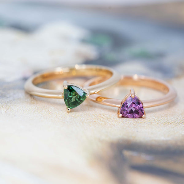 green sapphire and purple pink garnet minimalist bridal ring bena jewelry montreal made on a dark background