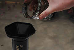 Person pouring coffee grinds into the Aeropress