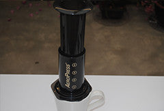 Aeropress sitting on top of a coffee mug