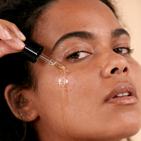 woman applying renew serum to face