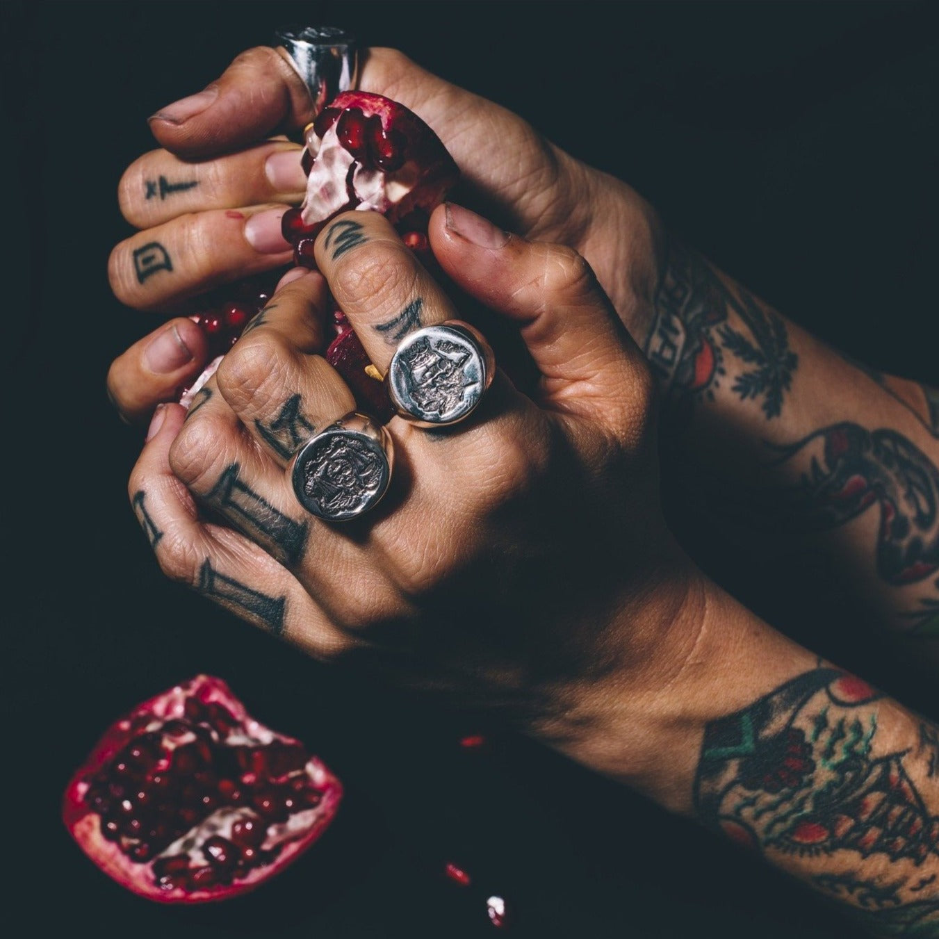 Tattooed hands with rings