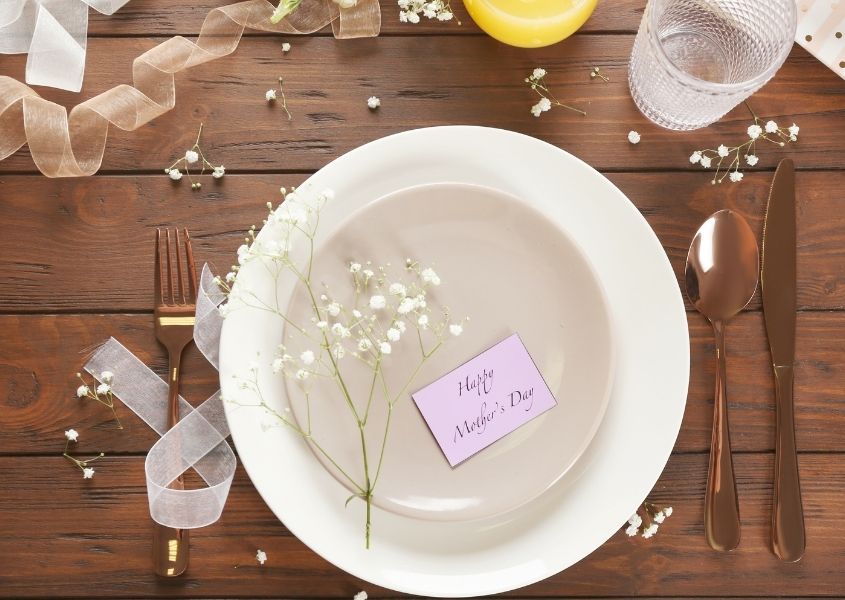 rustic dining table with white bowl and mother's day card