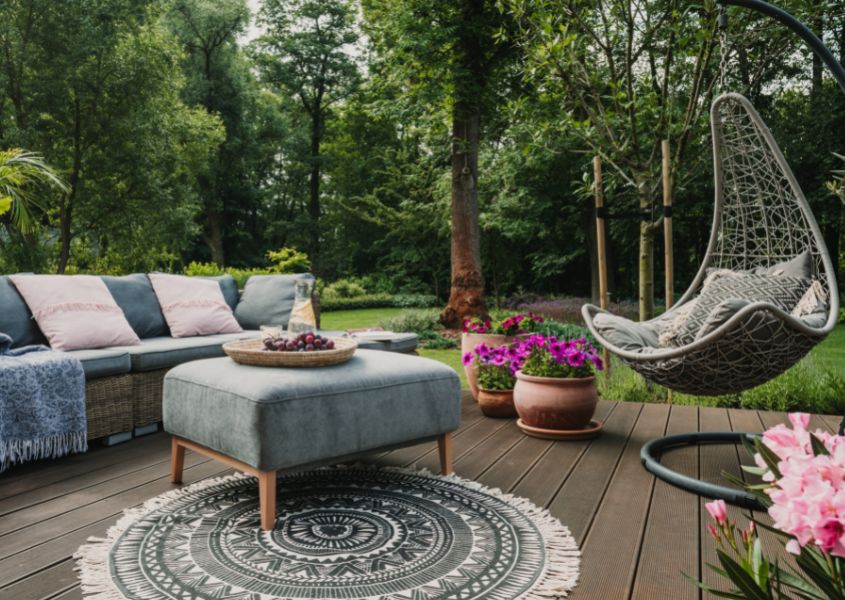 garden sofa with round circular rug and hanging egg tree