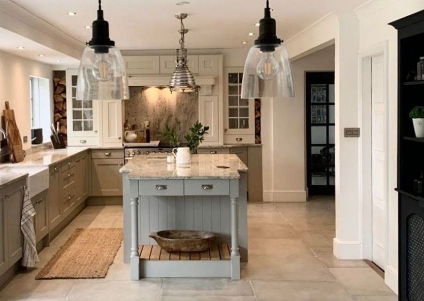 Pale grey shaker kitchen with kitchen island and glass hanging pendant lights