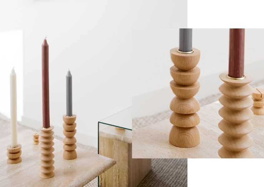 wooden totem candlesticks on a pale solid wood dining table
