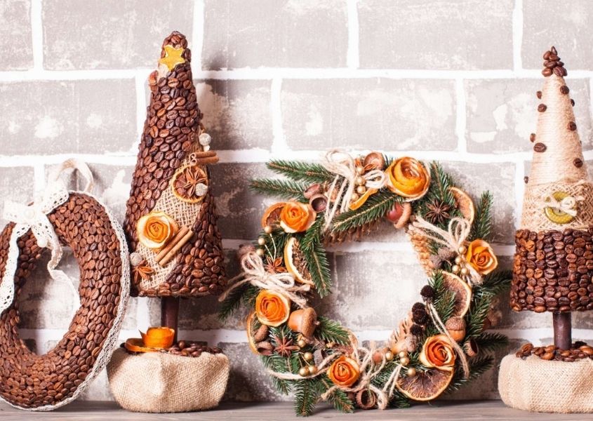 Assortment of homemade and rustic Christmas decorations against a brick wall