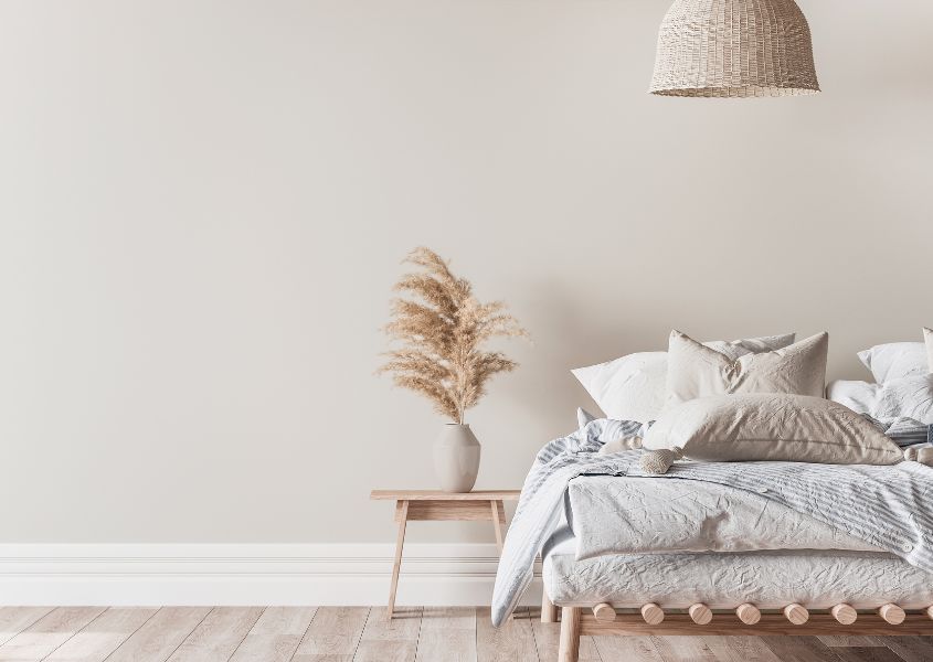 farmhouse bedroom with rattan pendant light and stone vase with pampers grass accessory