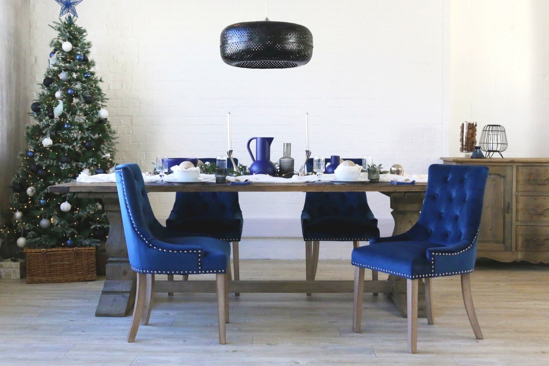 reclaimed wood dining table and blue velvet dining chairs with Christmas tree